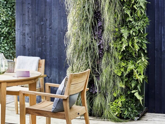 Dark fence with living wall and outdoor dining area