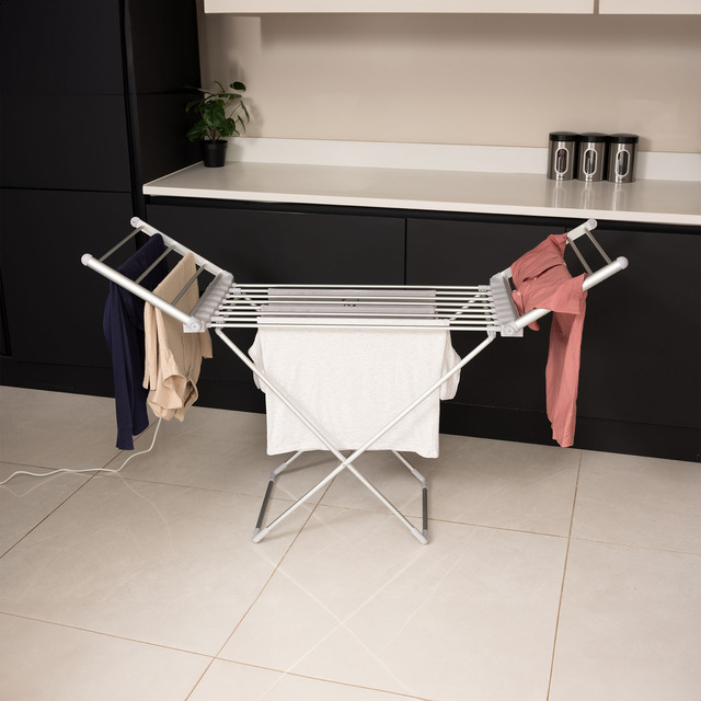 Heated airer with clothes hanging off in laundry room