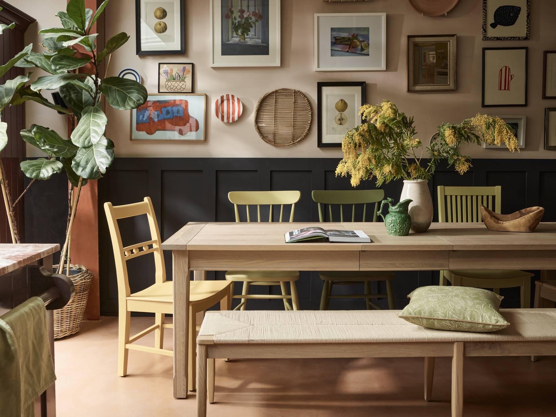 mustard and green dining chairs with long wooden table