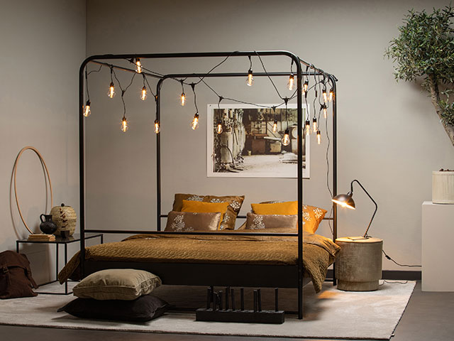 String your bed with fairy lights to tap into the fairycore look