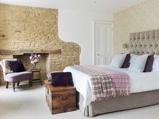 bedroom with exposed stone wall