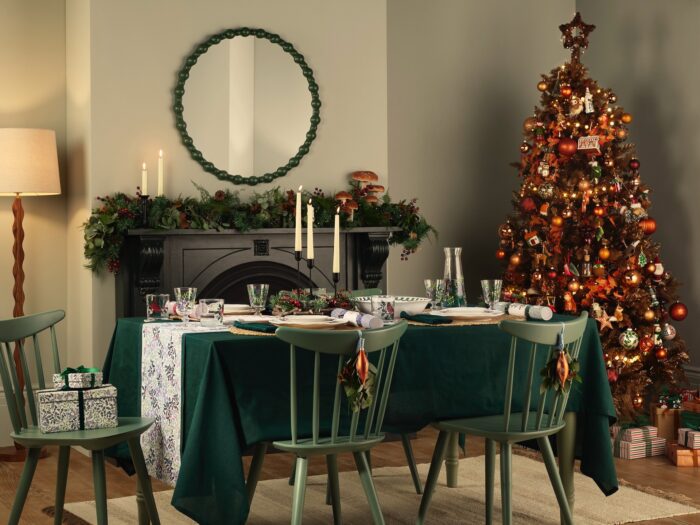 Dining room with artificial Christmas tree and green table and chairs
