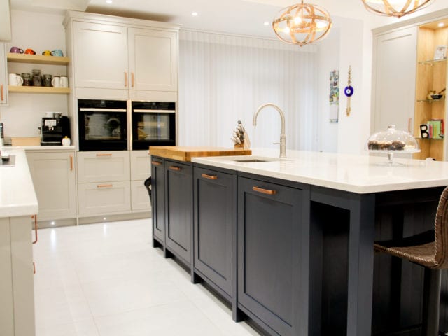 modern shaker kitchen in cream with island in dark blue