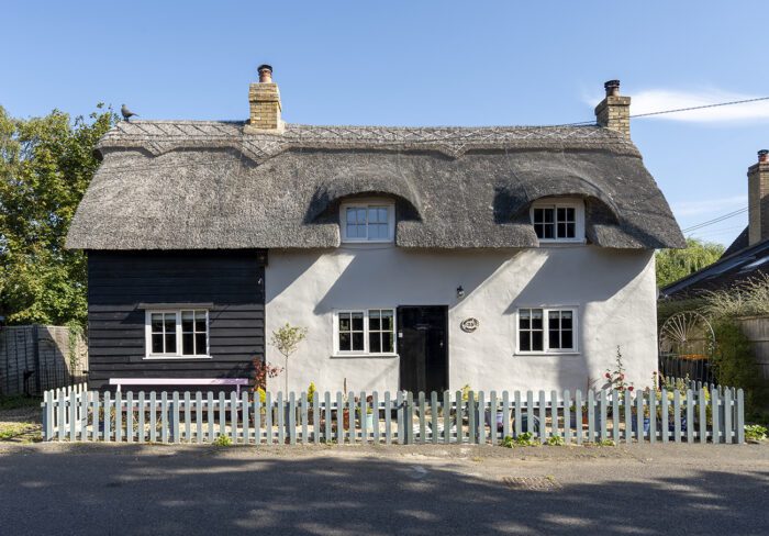 The original bright pink exterior of the house wasn’t quite right for Kerry and Paul. ‘It was patchy and not an attractive colour.’ The faded black boarding has been repainted and the exterior is now a calm Purbeck Stone by Farrow & Ball, with a smart black front door.