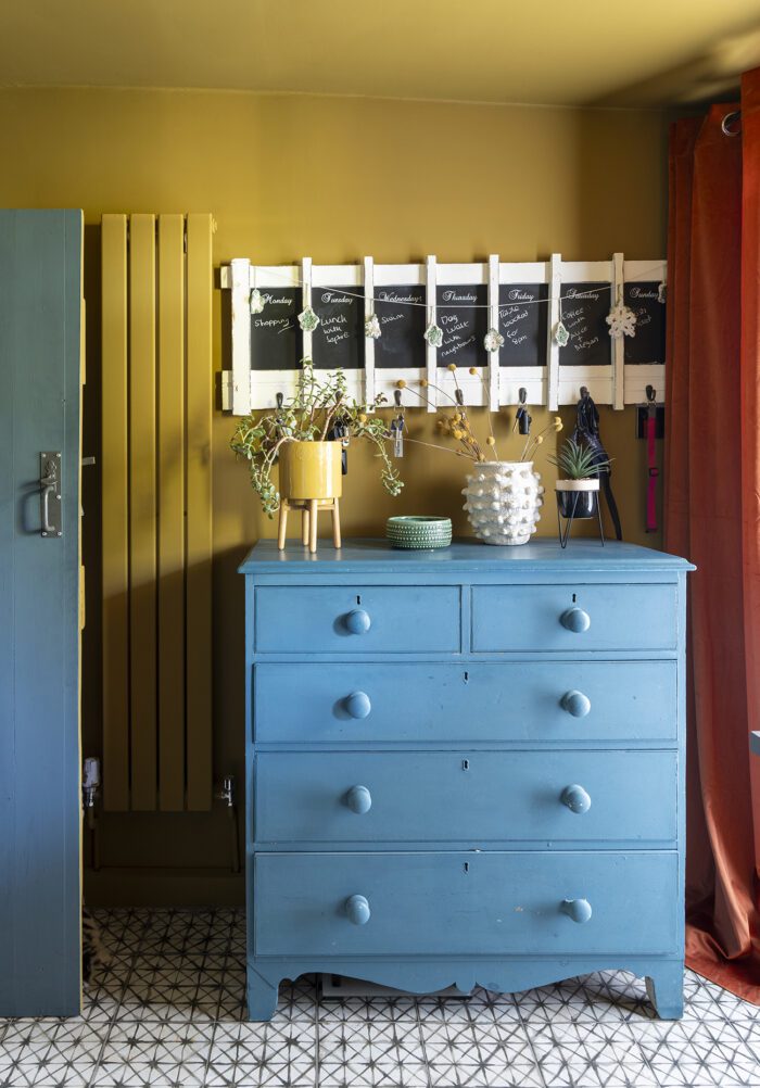 The mini utility room is painted in a glorious rich yellow, House of Hackney’s Umber, and Kerry has added a blue chest of drawers for storage and a memo board.
‘Originally we bought the drawers from an antique shop for upstairs, but they didn’t fit, so they’ve come in useful here for storage.’ 
