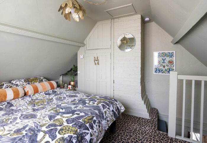 In the second guest bedroom, animal bedding, Jaguar Jungle by Emma J Shipley, is matched by Javon leopard print carpet from Online Carpets, echoing the carpet in the office, while the walls are off white. ‘A gold Farrar light from Dunelm catches the eye and I’ve framed a piece of Emma’s wallpaper that I used on the stairs to add a bit of drama.’