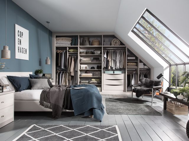 a fitted wardrobe and storage space by Sharps in a small bedroom of a real home