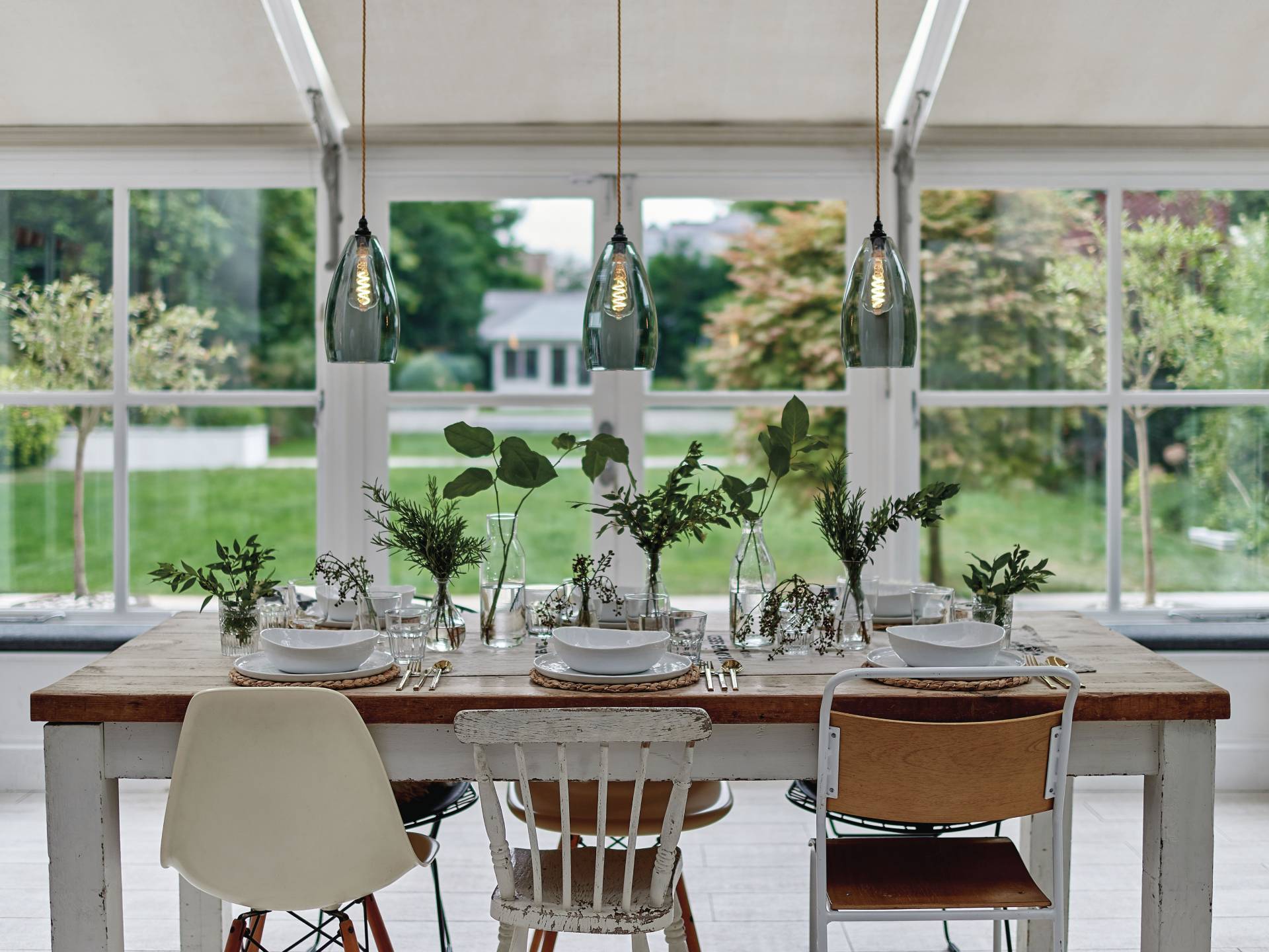 Rustic dining room with pendant lights and mixed style dining chairs