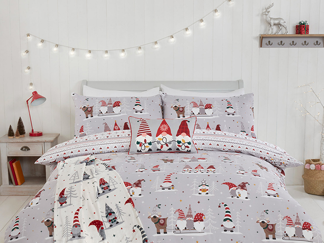 Christmas gonk bedding in a grey and white bedroom with fairy lights