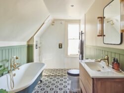 Attic bathroom with patterned tile floor, walk-in shower and green panelling