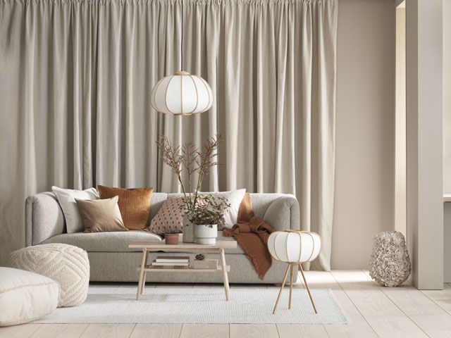 h&m home bamboo light and floor lamp with a sofa in a living room