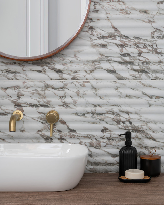Textured tiles behind sink in bathroom