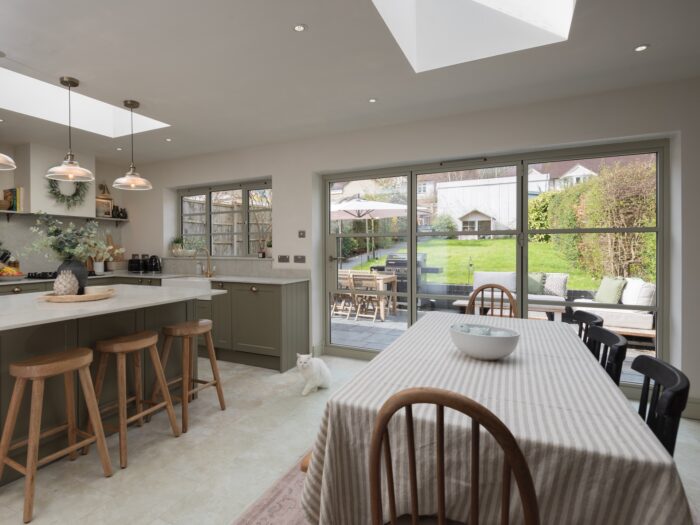 Kitchen diner with neutral bi-fold doors looking out onto patio