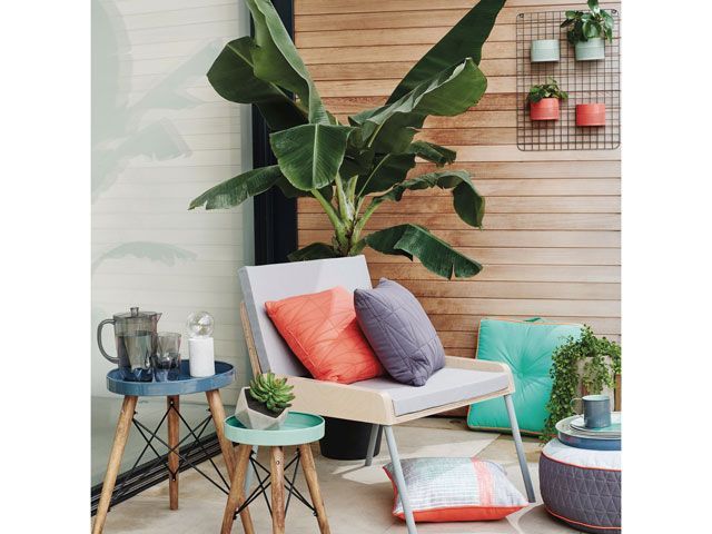 outdoor chair with cushions and tropical plants from Sainsbury's Home SS19 collection