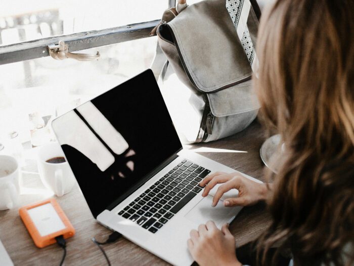 Woman working on a laptop in a cafe