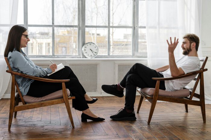 A man in a therapy session with a female therapist