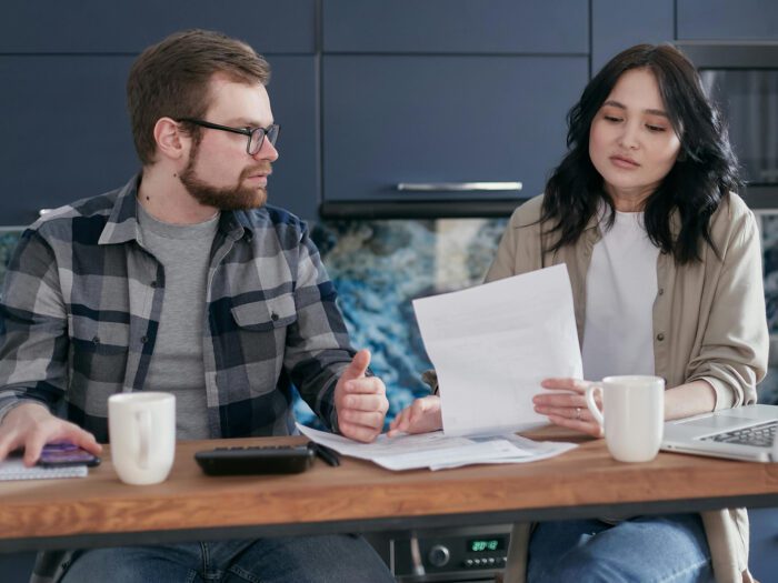 A couple sitting discussing some paperwork