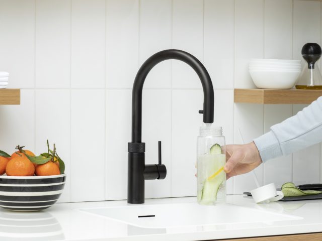 black hot water tap in white kitchen