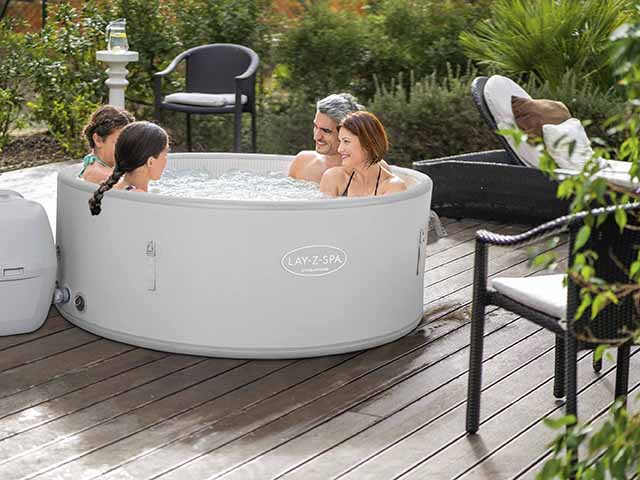 Singapore Airjet Plus Lay-Z-Spa with four guests on decking, goodhomesmagazine.com