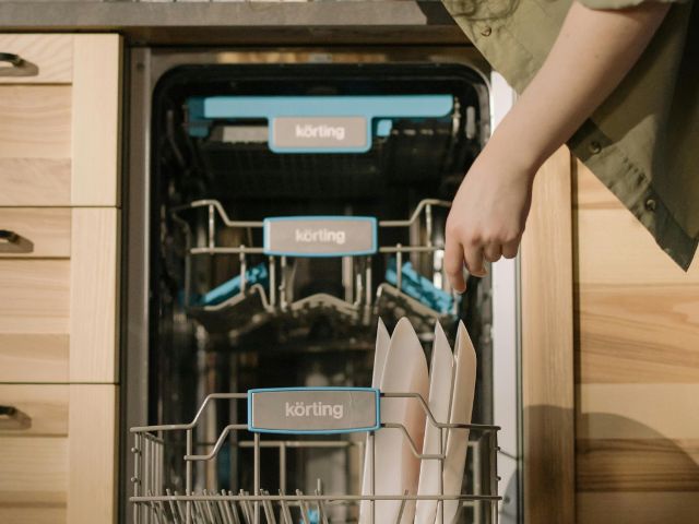 Woman loading a dishwasher