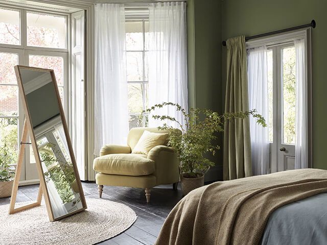 light green velvet heavy curtains layered with soft white sheers in bedroom
